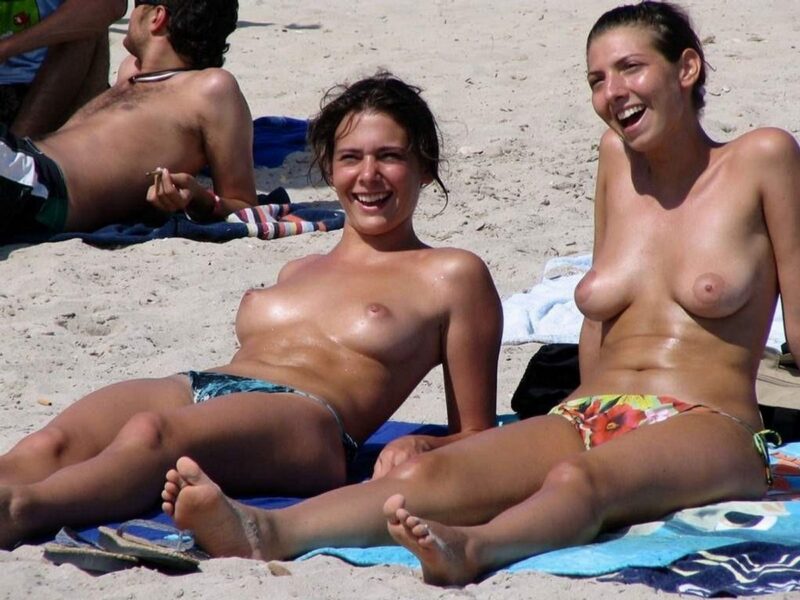 Two busty brunette girls topless on the beach
